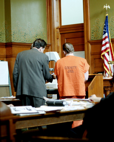 Lawyer representing a client in a post-conviction appeal in front of a judge.